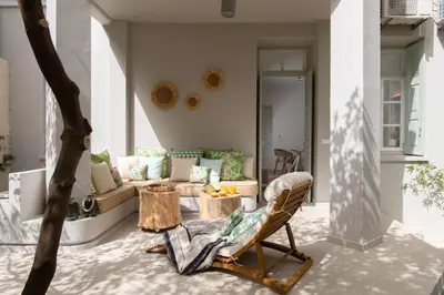 a living room with a couch and a chair at Casa Blue Dove in Chania Town