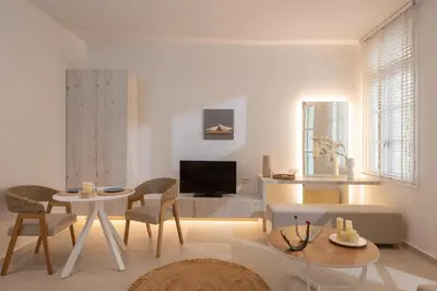 a living room with a table and chairs and a tv at Casa Blue Dove in Chania Town