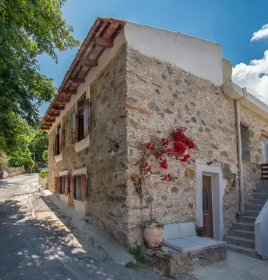a building with flowers on the side of it at Feneri 3 -Cozy rustic Apt 20' from Elafonisi beach in Elafonisi