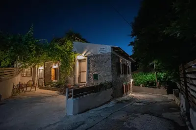 a house with lights on the side of it at night at Feneri 3 -Cozy rustic Apt 20' from Elafonisi beach in Elafonisi