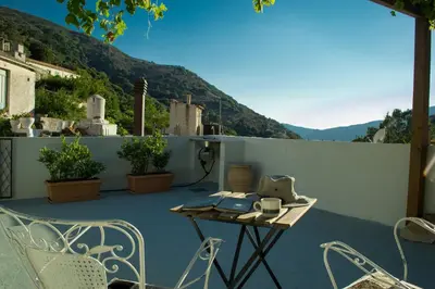 a patio with a table and chairs on a balcony at Feneri 3 -Cozy rustic Apt 20' from Elafonisi beach in Elafonisi