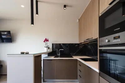 a kitchen with a sink and a stove top oven at VillAgioi - Luxury villas, Private Pools, 450m to the Beach in Chania Town