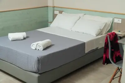 a bed with two rolled towels on top of it at Stefanie Studios in Agia Marina Nea Kydonias