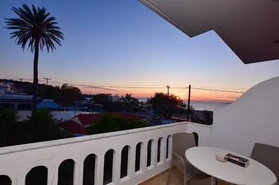 a balcony with a table and a view of the ocean at PALEOCHORA FINIKAS Apartments in Palaiochóra