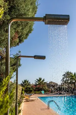 a water fountain next to a swimming pool at Maleme Yoga Blue in Chania Town
