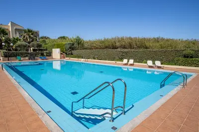 a large swimming pool with a slide in it at Maleme Yoga Blue in Chania Town