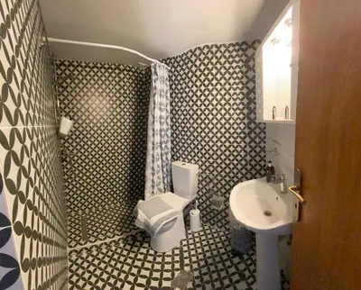 a bathroom with a toilet and a sink at Garden House in Khóra Sfakíon