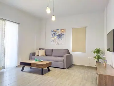a living room with a couch and a coffee table at Sea Side View Home steps from the beach & city in Chania Town