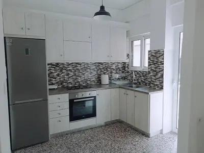 a kitchen with white cabinets and a stove top oven at Oksana House in Chania Town