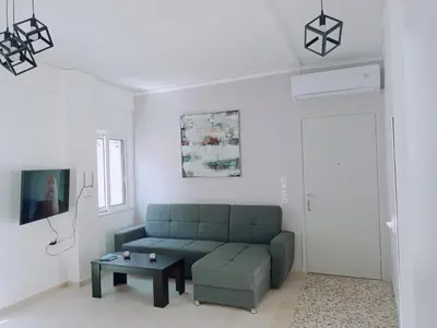 a living room with a green couch and a table at Oksana House in Chania Town