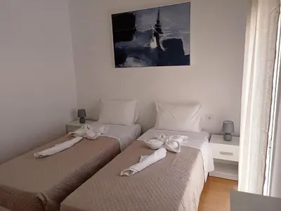 two beds with bows on them in a bedroom at Oksana House in Chania Town