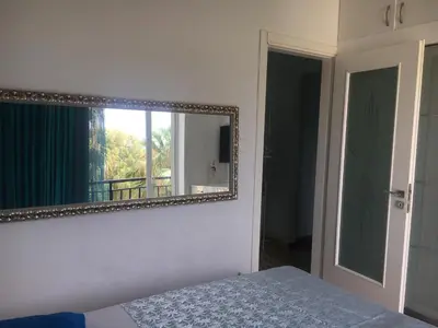 a mirror on the wall of a bedroom with a bed at At the Beach! +10min= port&center. in Chania Town