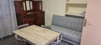 a room with a table and a couch and a table and chairs at Fifi's luxury apartment in Plataniás