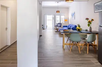 a dining room and living room with a table and chairs at Casa In Centro Chania in Chania Town