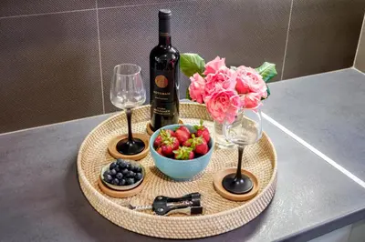 a tray with a bottle of wine and a bowl of fruit at Casa In Centro Chania in Chania Town