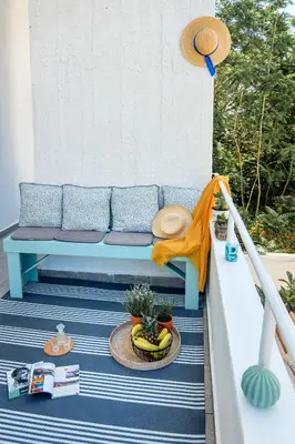 a blue couch sitting on a porch with a plant at Casa In Centro Chania in Chania Town