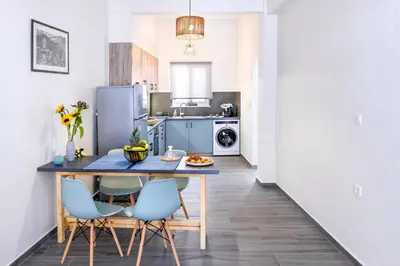 a kitchen with a table and chairs in a room at Casa In Centro Chania in Chania Town