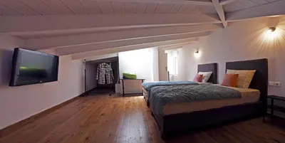 a bedroom with a bed and a flat screen tv at Ariadne Luxury Home in Chania Town