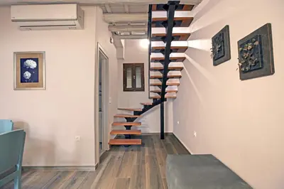 a spiral staircase in a room with wooden floors at Ariadne Luxury Home in Chania Town