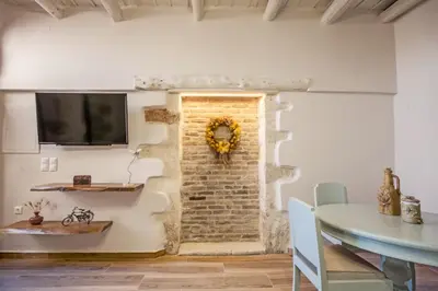 a dining room with a brick wall and a table at Ariadne Luxury Home in Chania Town