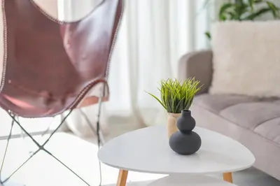 a table with a vase and a plant on it at Moka Apartments in Chania Town