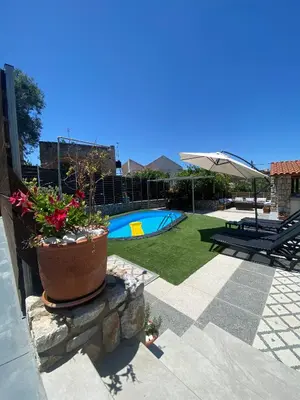 a patio with a potted plant and a pool at Casa Christina-Luxury Villa in Kissamos