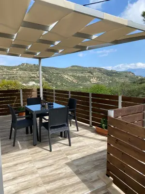 a patio with a table and chairs under a pergola at Casa Christina-Luxury Villa in Kissamos