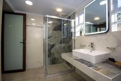 a bathroom with a sink and a shower at Casa Christina-Luxury Villa in Kissamos