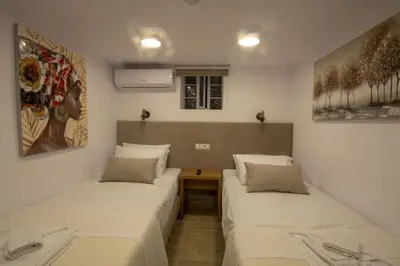 a room with two beds and a table in it at Casa Christina-Luxury Villa in Kissamos