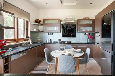 a kitchen with a small table and chairs in it at Bay Overlook Villa in Korakiaí