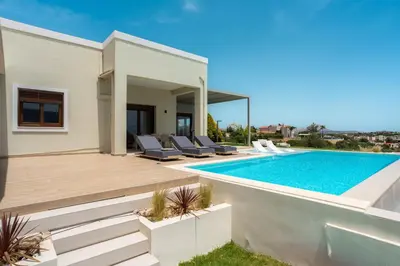 a villa with a swimming pool and a house at Bay Overlook Villa in Korakiaí