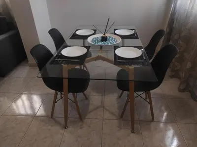 a dining room table with black chairs and a glass table at NickTheGreekApartment in Galatás