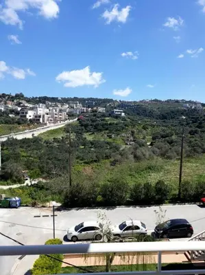 a parking lot with cars parked in a parking lot at Premium, 2-bedroom Apartment! in Chania Town
