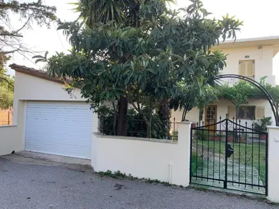 a garage door with a tree in front of a house at VILLA FATIMA in Vryses