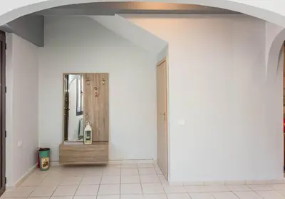 an empty hallway with a mirror and a door at Neoria apartment in Chania Town