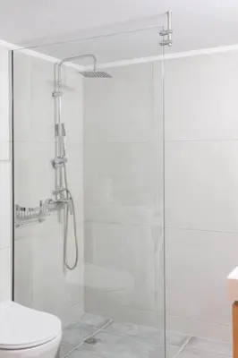 a bathroom with a glass shower with a toilet at Neoria apartment in Chania Town