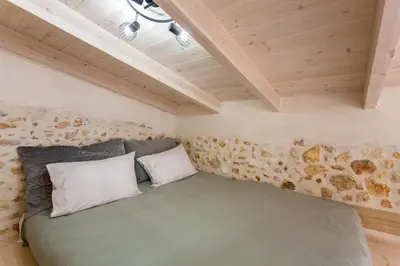 a bedroom in a tiny house with a green bed at Casa Athelia: Traditional Home, Local Neighborhood in Chania Town