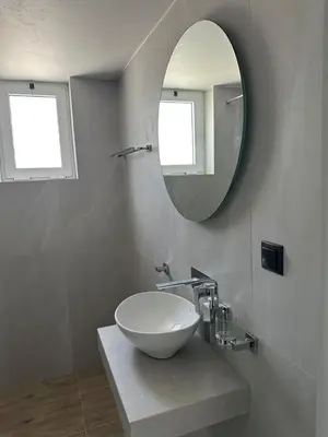 a bathroom with a bowl sink and a mirror at Electra Studios in Palaiochóra