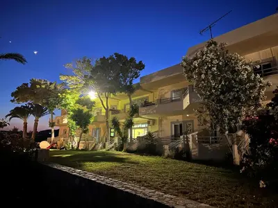 a large house with a lawn in front of it at Electra Studios in Palaiochóra