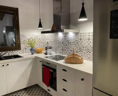 a kitchen with white cabinets and a basket on the counter at Katikies Savrani in Perivólia