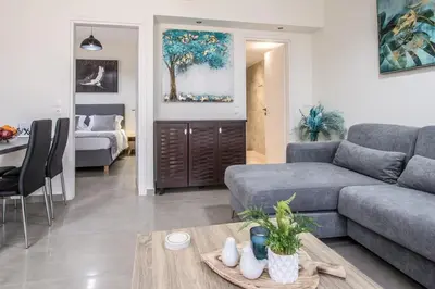 a living room with a couch and a table at Luxury Katsoulakis Apartments in countryside in Alikianós