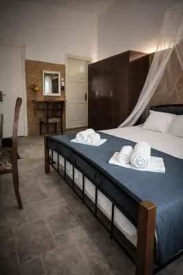 a bedroom with a large bed with towels on it at Aloni Studio in Azoyirás