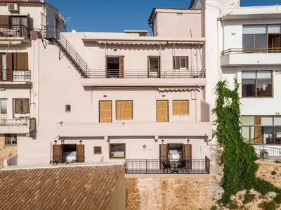an apartment building with white walls and a roof at La vista de Pablo in Chania Town