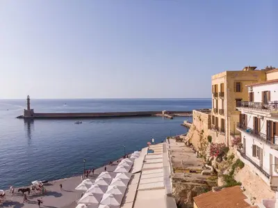 a view of a beach with buildings and the ocean at La vista de Pablo in Chania Town