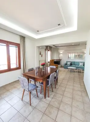 a dining room with a wooden table and chairs at Rastoni Chania - Guests Apartment in Chania Town