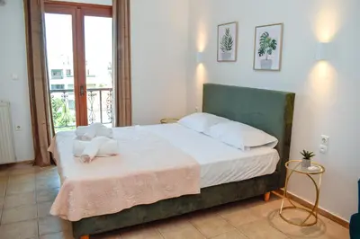 a bedroom with a bed with white sheets and pillows at Rastoni Chania - Guests Apartment in Chania Town