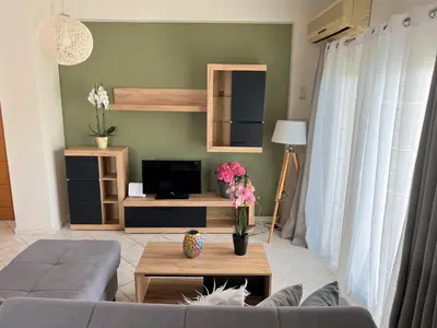 a living room with a couch and a tv at Antonis Kavros appartment in the center of chania in Chania Town
