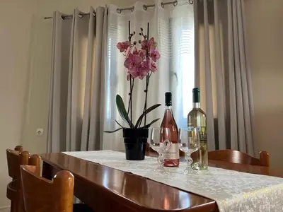 a table with two bottles and two glasses of wine at Antonis Kavros appartment in the center of chania in Chania Town
