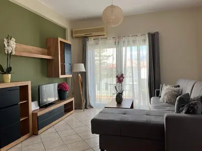 a living room with a couch and a tv at Antonis Kavros appartment in the center of chania in Chania Town