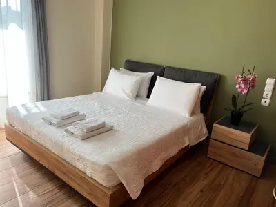 a bedroom with a bed with two towels on it at Antonis Kavros appartment in the center of chania in Chania Town